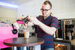 © Cavan Images - Confident barista making coffee at cafe
