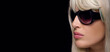 © Casther - Beautiful blond woman in sunglasses. Fashion women eyewear panorama banner isolated on black background.