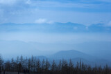 Fototapeta  - Japan mountain range in hazy blue sunshine.