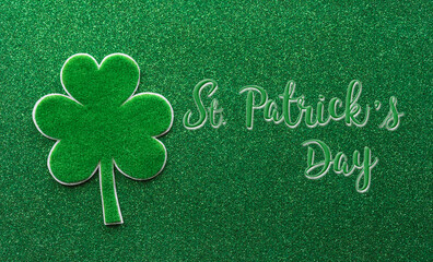 Wall Mural - Happy St Patrick's Day decoration concept made from shamrocks ( clover leaf) and the text on green background.
