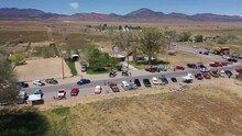 Aerial Drone Shot Of Car Show On Rural Desert Highway In Small Western Town