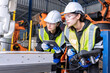 © Tongpool - Women engineer team together at work in modern advanced robot welding machine sell service factory