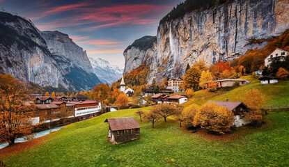 Fototapete - Wonderful nature sunny landscape. Scenic image of fairytale alpine valley Lauterbrunnen during sunset.  Picturesque view of nature. Lauterbrunnen iconic location for landscape photographers.
