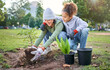 © N Felix/peopleimages.com - Woman, child and nature park with a plant for gardening trees or agriculture in garden. Happy volunteer family team helping and planting growth, ecology and sustainability for community on Earth day