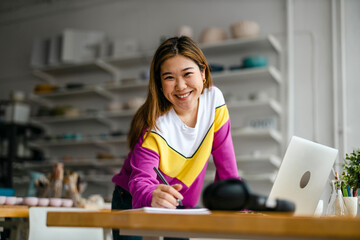 Canvas Print - Young female freelancer working in loft office
