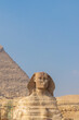 Vertical front view of giza Sphinx, marvelous wonder of the world with the pyramid in the background in Caire, Egypt