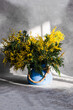 © ADDICTIVE STOCK - Vase with spring yellow mimosa flowers