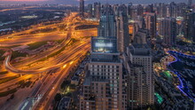 Dubai Marina And JLT Skyscrapers Along Sheikh Zayed Road Aerial Night To Day .