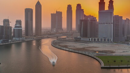 Wall Mural - Sunset cityscape of skyscrapers in Dubai Business Bay with water canal aerial