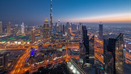 Wall Mural - Aerial view of tallest towers in Dubai Downtown skyline and highway day to night .