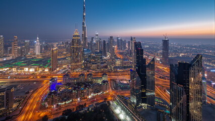 Canvas Print - Aerial view of tallest towers in Dubai Downtown skyline and highway day to night .