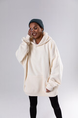 Wall Mural - Attractive african american woman in oversized white hoodie. Mock-up.
