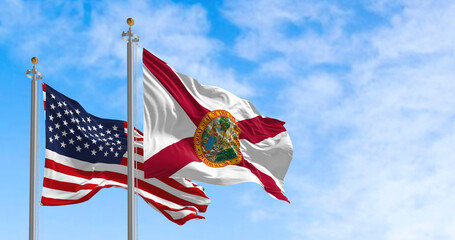 Wall Mural - The Florida state flag waving along with the national flag of the United States of America