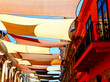 © Istvan - street awnings in perspective. colorful canvas sail shade and UV protection fabric suspended from exterior walls over the urban street in old city downtown area. sun protection. summer holiday concept
