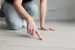 © megaflopp - Woman housewife pointing finger at dirt on floor with laminate closeup