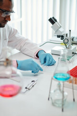 Wall Mural - Laboratory worker checking blood of patient for diseases and viruses
