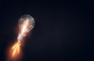 Wall Mural - Light bulb over dark black background. Concept of creativity and innovation