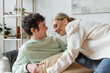 © LIGHTFIELD STUDIOS - cheerful young couple laughing while having pillow fight in living room.