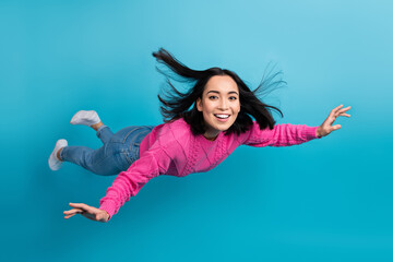 Poster - Full length photo of carefree adorable lady wear pink pullover arms wings flying air isolated blue color background