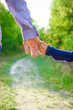 © Kostia - the parent holding the child's hand with a happy background