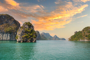 Wall Mural - Halong Bay, Vietnam, with limestone hills and sunset sky. landscape of Ha Long bay with sunset sky, a UNESCO world heritage site and a popular tourist destination.