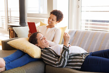 Happy Diverse Lesbian Couple Sitting On Sofa, Looking At Usg Scan And Embracing