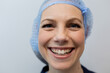 © Wavebreak Media - Portrait of happy caucasian female doctor wearing hair net working at hospital