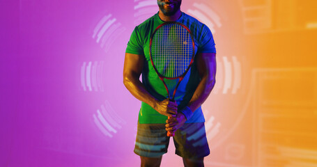 Wall Mural - Midsection of african american male tennis player with racket standing over circular pattern