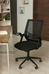 Poster - Stylish office chair at workplace in room. Interior design