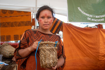 Wall Mural - Ashaninka artisan woman with a basket made of palm fronds