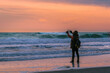 © Jay - A tourist taking video of huge ocean waves in Robert Moses State Park, New York during an evening
