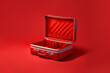 Opened vintage suitcase of stylish empty vintage square suitcase with red textile on red background. Generative AI image.