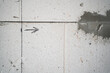 The line is drawn on a bare aerated concrete wall and the arrow is close-up. Drawn arrow at a construction site, copyspace
