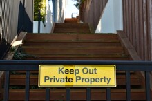 A Keep Out Private Property Sign On A Gate In A Suburban Property.