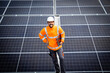 © littlewolf1989 - Portrait of solar panel engineer standing inside sustainable energy power plant.