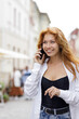 © skumer - Young beautiful smiling redhead woman talking on the phone