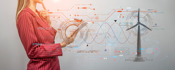 Businesswoman using tablet research information energy from wind mill turbine with double exposure of glowing digital wind mill turbine hologram, Wind generator and clean energy concept, Image panoram