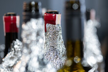 Close-up Of Bottle Necks Wrapped With Foil. Blind Wine Tasting. Training For Sommeliers