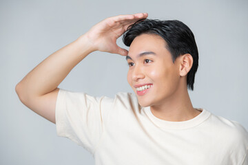 Wall Mural - Handsome man touching his hair close up portrait studio on white background