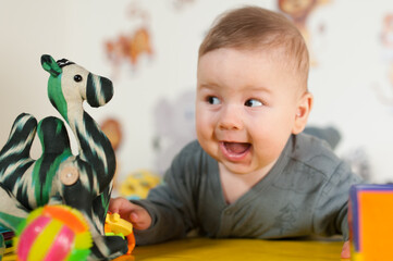 Wall Mural - Portrait view of cute amazed and surprised baby. Love and family emotion