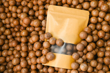 Poster - macadamia nuts on basket, fresh natural shelled raw macadamia nuts in a full frame, close up pile of roasted macadamia nut in bag package product