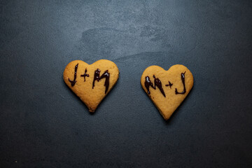 initials on heart shaped cakes. letters on christmas cookies. top view of romantic dry cakes. romantic cookie background