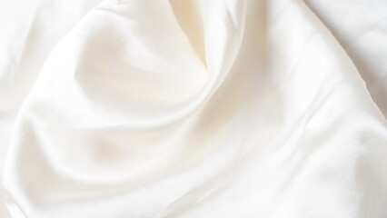 White silk fabric - soft, and delicate with shine, folds, creases. Smooth elegant silk  background