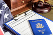 American passports and judges legal hammer on wooden desk.