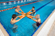 © zinkevych - Group of seniors having a swimming class at the swimming pool
