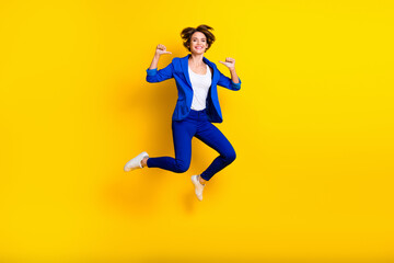 Full length photo of cool confident woman wear blue jumping high pointing thumbs herself isolated yellow color background