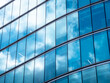 © VDZ3 Media - London UK - Close up of Business Financial district office headquarters within the modern skyscrapers. Blue clean modern glass wall with sky and cloud reflection. Capital city commercial district