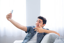Hispanic Teenager Boy Live Streaming Or Having Video Call On Phone. Influencer Creating Content.