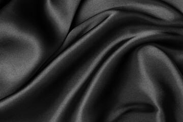 Wall Mural - Black fabric texture background, wavy fabric slippery black color, luxury satin cloth texture.