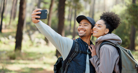 Canvas Print - Hiking, selfie and young couple in forest smiling, happy and enjoy nature together. Fitness, wellness and Asian man with black woman taking picture with phone on adventure, trekking and walk in woods